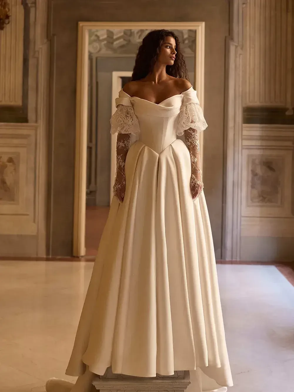 model is wearing a blousy sleeve wedding dress