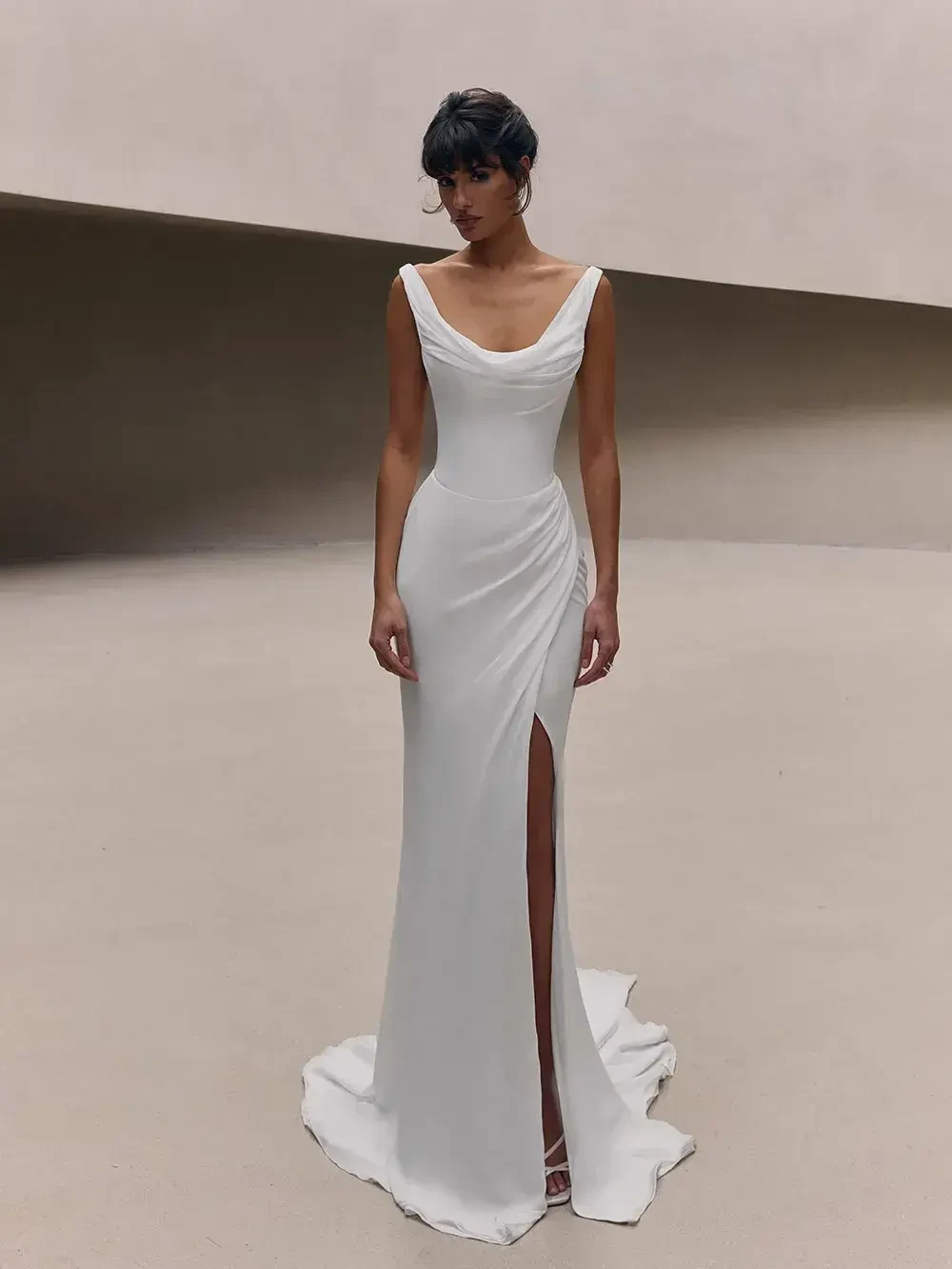 model is wearing a sleeveless bridal gown