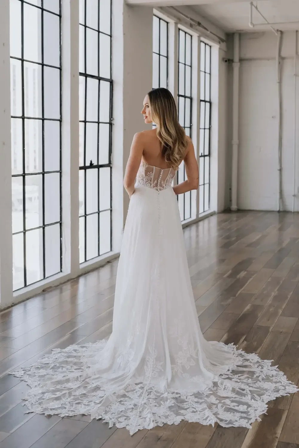 model is wearing a sleeveless chiffon wedding dress