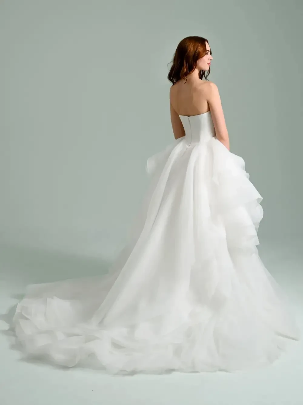 model is wearing a strapless ball gown