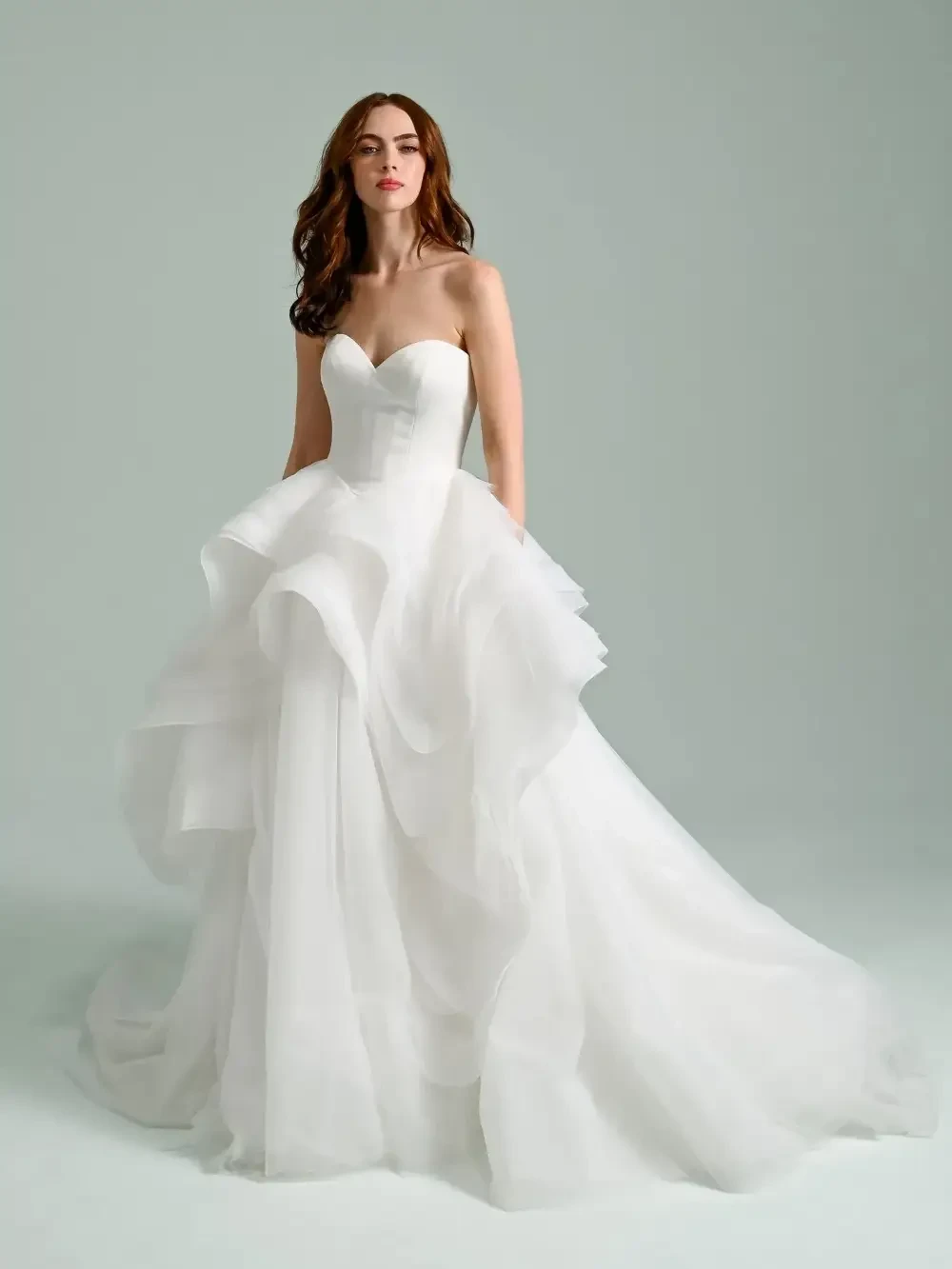 model is wearing a strapless ball gown